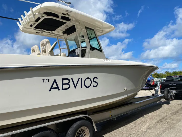 Abvios Yacht Photos Pics 2020 Boston Whaler 330 Outrage boat on trailer under blue sky.