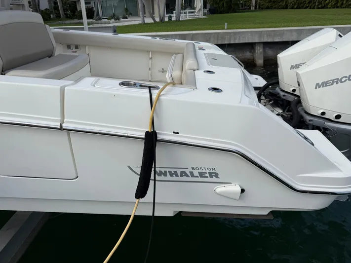 Abvios Yacht Photos Pics 2020 Boston Whaler 330 Outrage boat with dual Mercury engines docked.