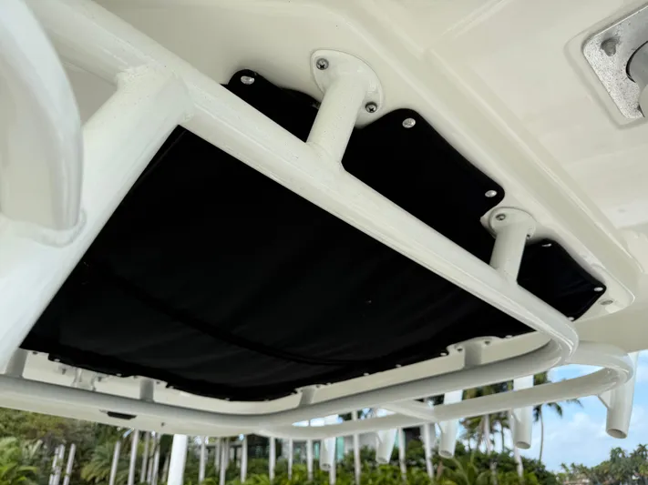 Abvios Yacht Photos Pics 2020 Boston Whaler 330 Outrage boat detail, featuring sturdy white framework and black canvas.
