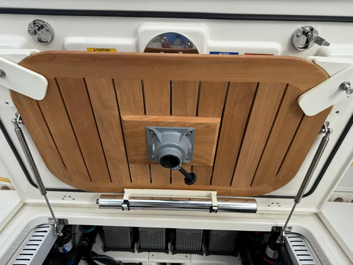 Abvios Yacht Photos Pics 2020 Boston Whaler 330 Outrage boat hatch with wooden cover and metal fittings.