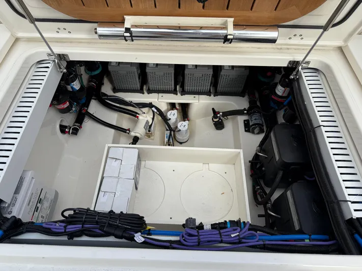 Abvios Yacht Photos Pics 2020 Boston Whaler 330 Outrage battery compartment with organized wiring and components.
