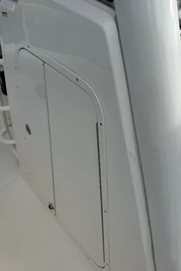 Abvios Yacht Photos Pics 2020 Boston Whaler 330 Outrage boat compartment door, white exterior detail.