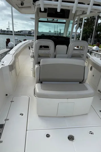 Abvios Yacht Photos Pics 2020 Boston Whaler 330 Outrage boat interior with seating and helm station.