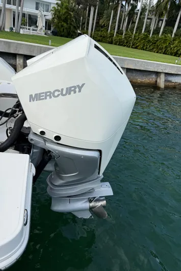 Abvios Yacht Photos Pics 2020 Boston Whaler 330 Outrage with Mercury outboard engine, docked in calm waters.