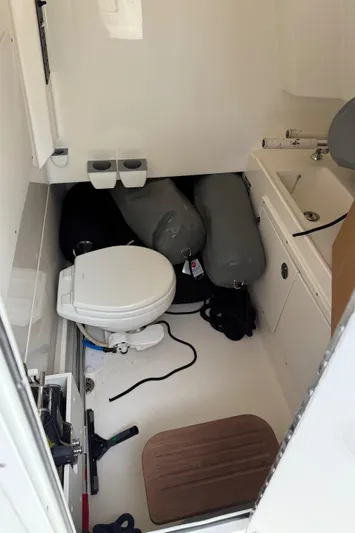 Abvios Yacht Photos Pics 2020 Boston Whaler 330 Outrage interior with toilet, sink, and storage space.