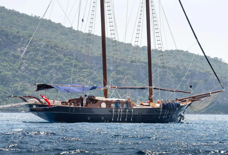 Ocean Pure Yacht Photos Pics Custom 1993 Gulet Motorsailer sailing near lush, green hills.