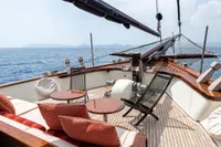 Luxurious 1993 Custom Gulet Motorsailer deck with seating, ocean view, and elegant wood finish.