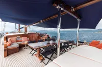 Luxurious 1993 Custom Gulet Motorsailer deck with seating, dining area, and ocean view.