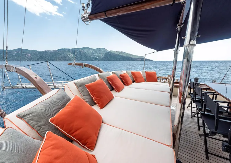 Ocean Pure Yacht Photos Pics Luxurious 1993 Custom Gulet Motorsailer deck with cushioned seating and ocean view.