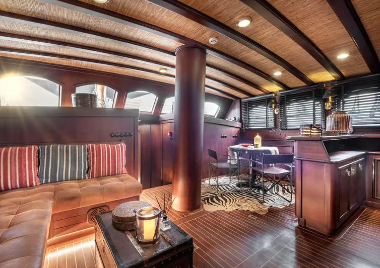 Ocean Pure Yacht Photos Pics Luxurious interior of 1993 Custom Gulet Motorsailer with elegant wood finishes and cozy seating.