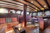 Luxurious interior of 1993 Custom Gulet Motorsailer with elegant wood finishes and cozy seating.