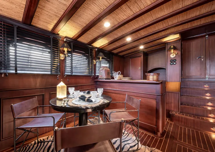 Ocean Pure Yacht Photos Pics Luxurious wooden interior of 1993 Custom Gulet Motorsailer with elegant dining area and ambient lighting.
