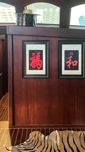 Ocean Pure Yacht Photos Pics Interior of 1993 Custom Gulet Motorsailer with framed Asian art and wooden paneling.