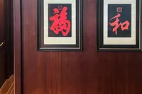 Interior of 1993 Custom Gulet Motorsailer with framed Asian art and wooden paneling.