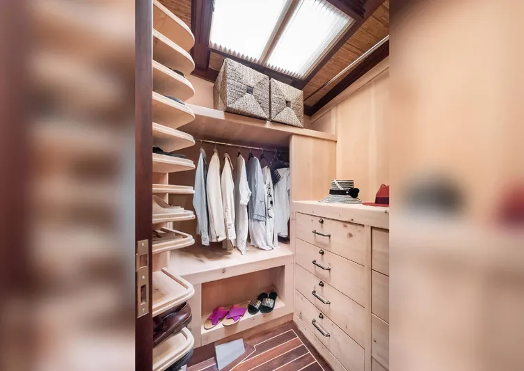 Ocean Pure Yacht Photos Pics Luxurious wooden closet on 1993 Custom Gulet Motorsailer with clothes, shoes, and accessories.