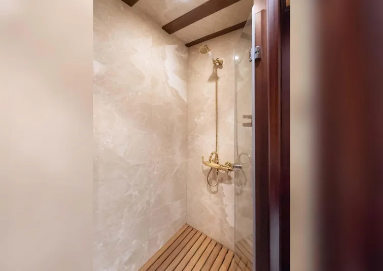 Ocean Pure Yacht Photos Pics Luxurious shower with marble walls and wooden floor on a 1993 Custom Gulet Motorsailer.