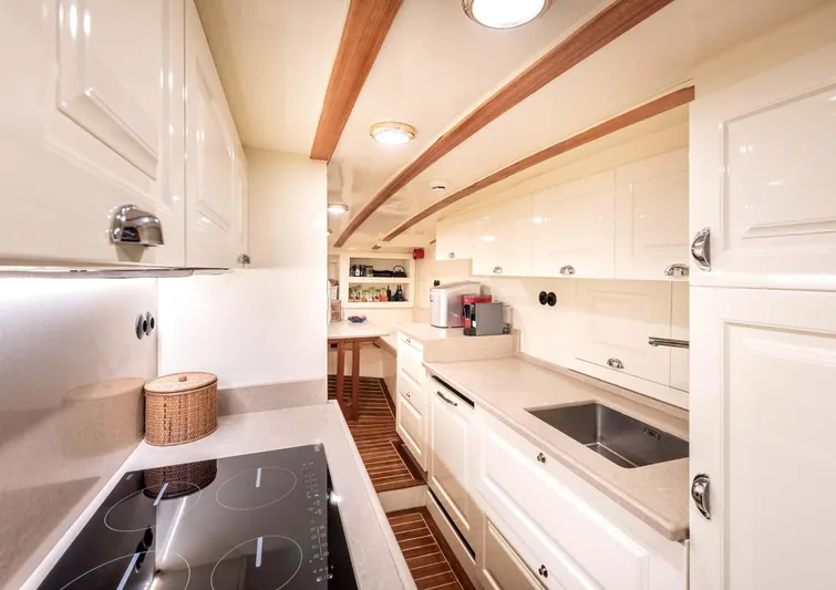 Ocean Pure Yacht Photos Pics Luxurious kitchen interior of 1993 Custom Gulet Motorsailer with modern appliances and sleek design.