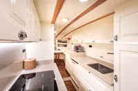 Luxurious kitchen interior of 1993 Custom Gulet Motorsailer with modern appliances and sleek design.