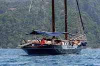 Custom 1993 Gulet Motorsailer sailing on blue waters near lush green coastline.
