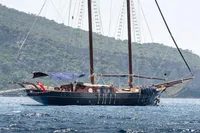 Custom 1993 Gulet Motorsailer sailing near a lush, mountainous coastline.