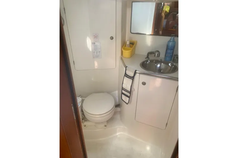  Yacht Photos Pics Bathroom interior of 2003 Jeanneau Sun Odyssey 45.2 yacht, featuring sink and toilet.