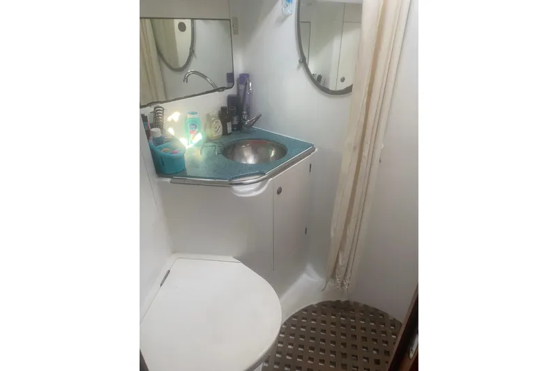  Yacht Photos Pics Bathroom interior of 2003 Jeanneau Sun Odyssey 45.2 yacht, featuring sink and mirror.