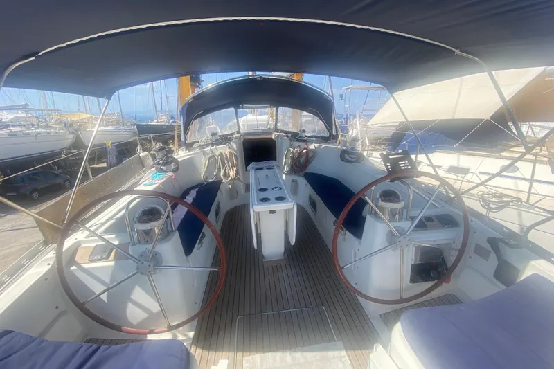  Yacht Photos Pics 2003 Jeanneau Sun Odyssey 45.2 sailboat cockpit with dual steering wheels and canopy.