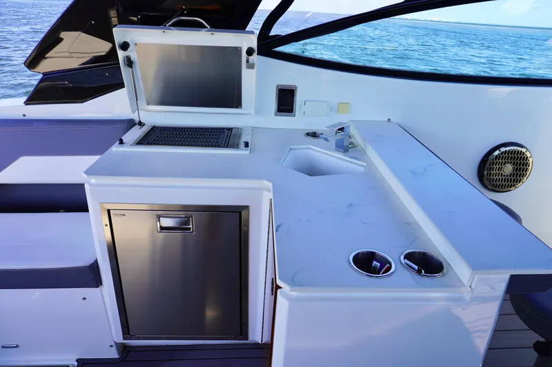  Yacht Photos Pics Outdoor kitchen on 2020 Cruisers Yachts 38 GLS OB, featuring grill and sink.