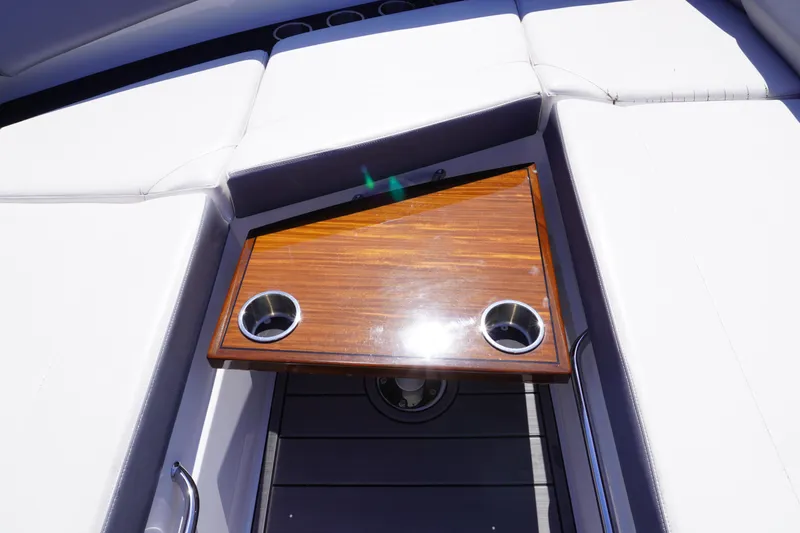  Yacht Photos Pics Luxury seating area on 2020 Cruisers Yachts 38 GLS OB with wooden table and cup holders.