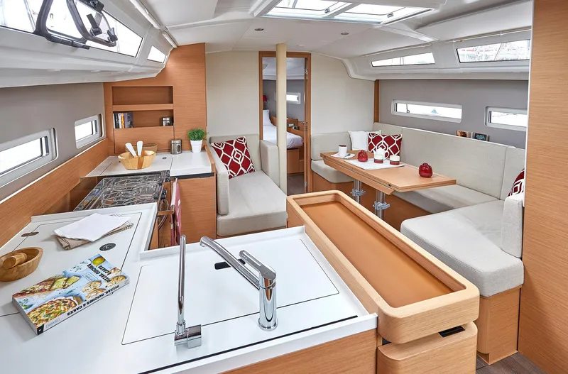 Vanilla IV Yacht Photos Pics Interior of 2023 Jeanneau Sun Odyssey 410 yacht, featuring modern kitchen and cozy seating area.
