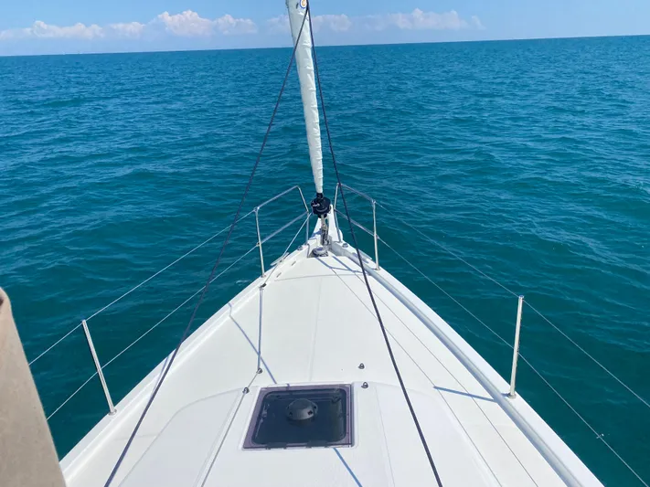 Vanilla IV Yacht Photos Pics 2023 Jeanneau Sun Odyssey 410 sailing on open sea, clear blue water.