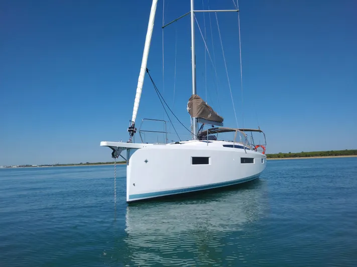Vanilla IV Yacht Photos Pics 2023 Jeanneau Sun Odyssey 410 sailboat on calm water under clear blue sky.