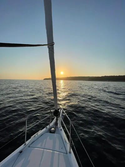 Vanilla IV Yacht Photos Pics Jeanneau Sun Odyssey 410 sailing at sunset, 2023 model, calm sea view.