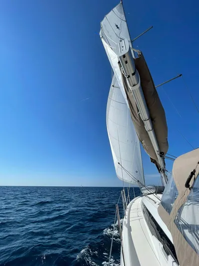 Vanilla IV Yacht Photos Pics 2023 Jeanneau Sun Odyssey 410 sailing on open sea under clear blue sky.