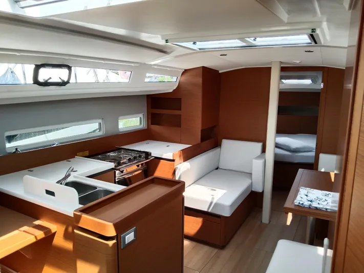 Vanilla IV Yacht Photos Pics Interior of 2023 Jeanneau Sun Odyssey 410 yacht, featuring modern kitchen and seating area.