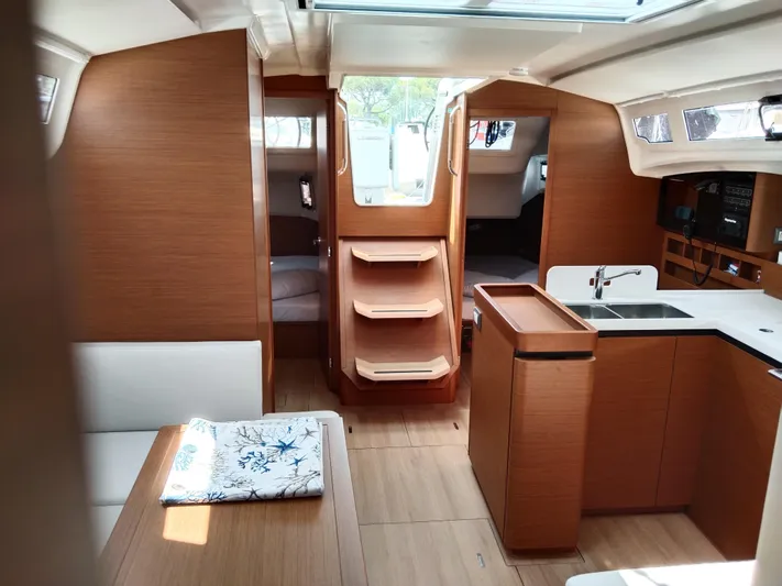 Vanilla IV Yacht Photos Pics Interior of 2023 Jeanneau Sun Odyssey 410 sailboat, featuring modern wood finish and spacious layout.