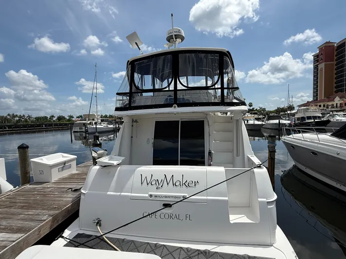  Yacht Photos Pics 2002 Silverton 410 Sport Bridge yacht docked in Cape Coral marina under a sunny sky.