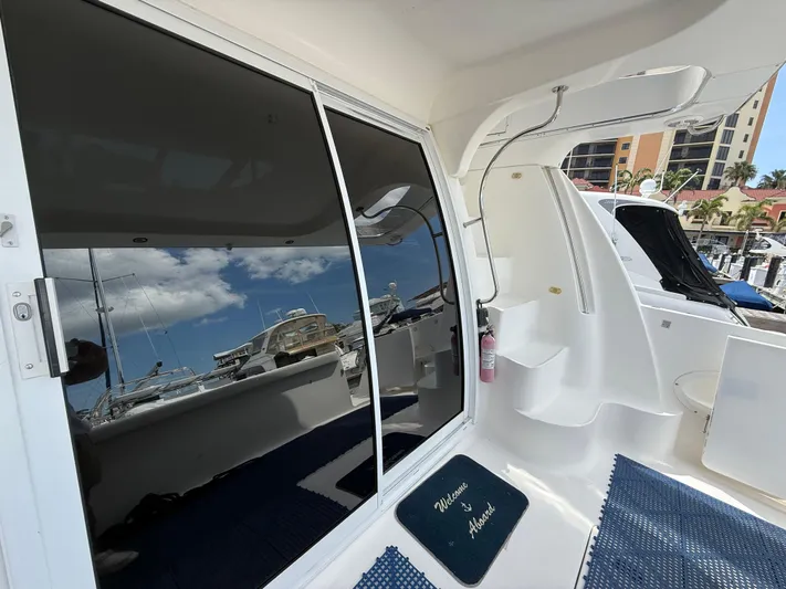  Yacht Photos Pics 2002 Silverton 410 Sport Bridge yacht with glass doors and marina view.