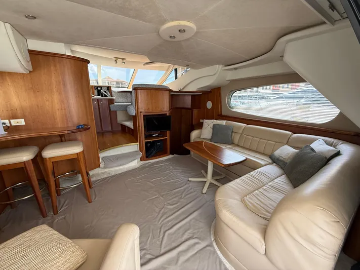  Yacht Photos Pics Luxurious interior of a 2002 Silverton 410 Sport Bridge yacht with leather seating and wooden accents.