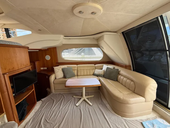  Yacht Photos Pics Interior of 2002 Silverton 410 Sport Bridge with beige leather seating and wooden accents.