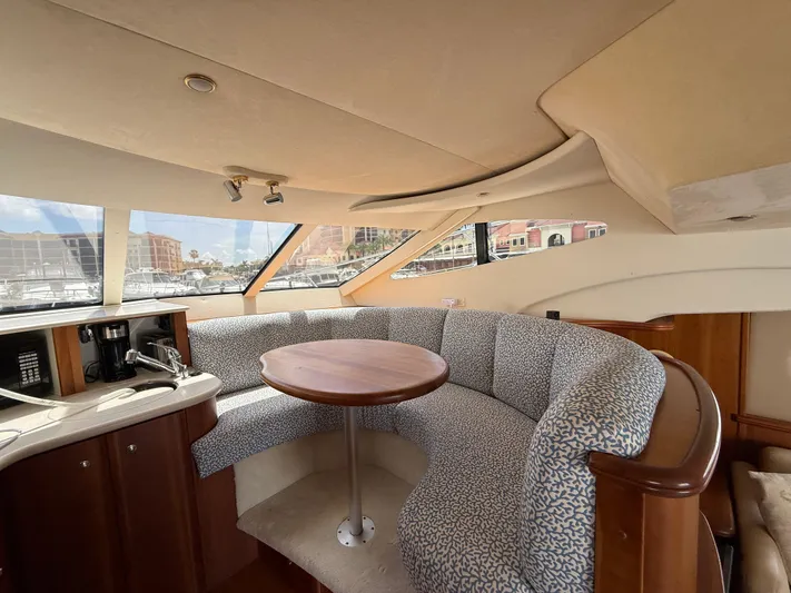  Yacht Photos Pics Interior of 2002 Silverton 410 Sport Bridge with curved seating and kitchenette.