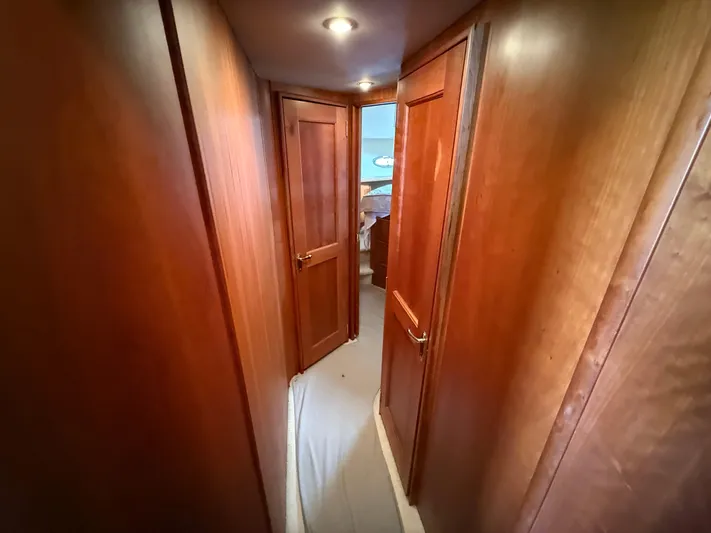  Yacht Photos Pics Narrow hallway with wooden doors inside a 2002 Silverton 410 Sport Bridge yacht.
