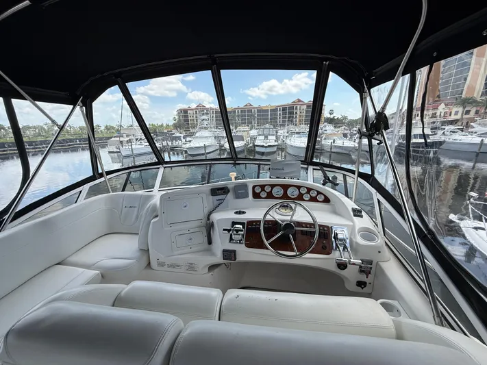  Yacht Photos Pics 2002 Silverton 410 Sport Bridge yacht interior with helm, docked at marina.