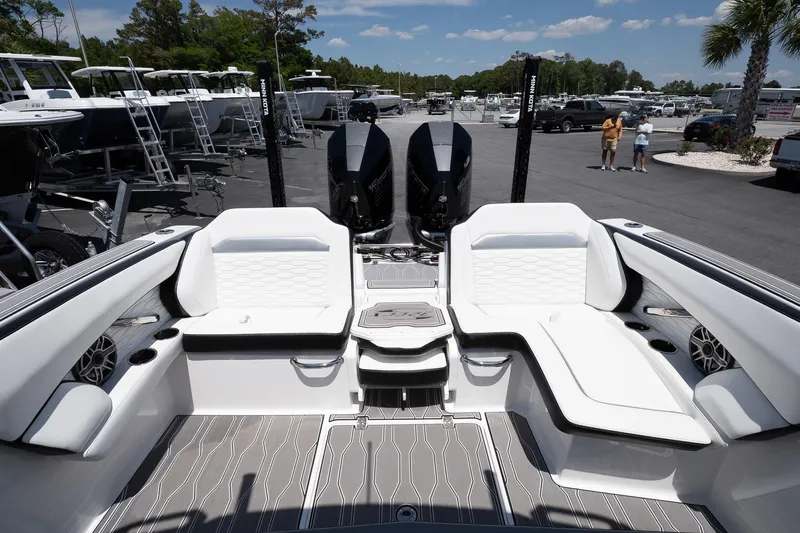  Yacht Photos Pics 2023 Sunsation 32 CCX boat interior with sleek seating and dual engines in a marina setting.