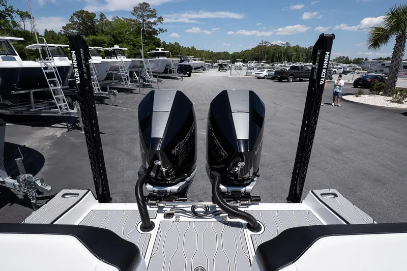  Yacht Photos Pics 2023 Sunsation 32 CCX boat with dual engines, parked outdoors under a clear sky.