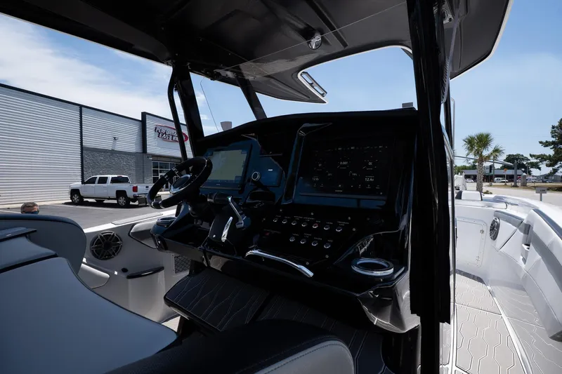  Yacht Photos Pics 2023 Sunsation 32 CCX boat cockpit with modern controls and steering wheel.
