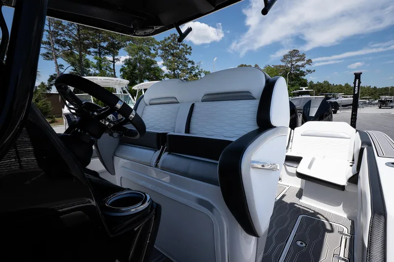 Yacht Photos Pics 2023 Sunsation 32 CCX boat interior with sleek seating and modern steering wheel.