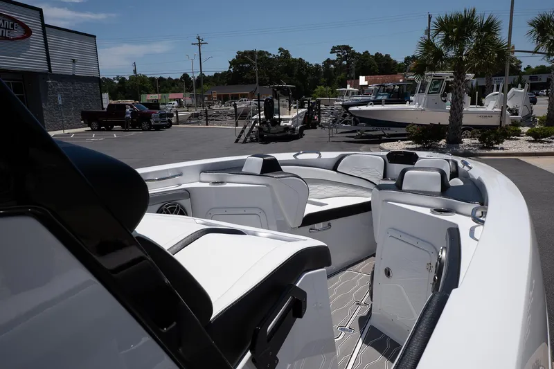  Yacht Photos Pics 2023 Sunsation 32 CCX boat interior with sleek seating and modern design in a marina setting.