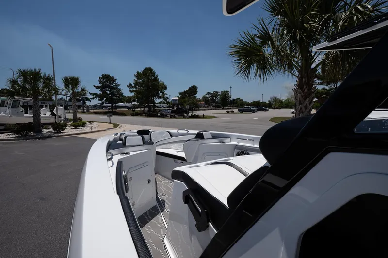  Yacht Photos Pics 2023 Sunsation 32 CCX boat parked, showcasing sleek design and spacious seating under clear blue sky.