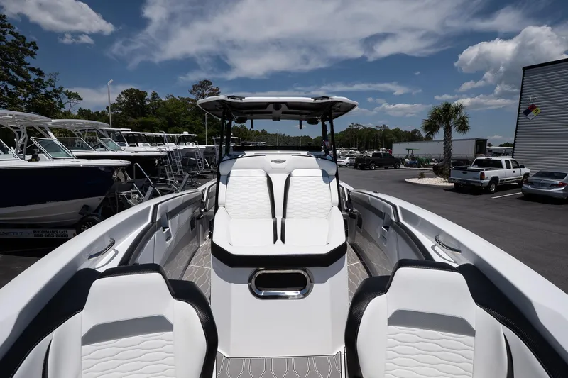  Yacht Photos Pics 2023 Sunsation 32 CCX boat with sleek white seating and modern design, docked under a blue sky.